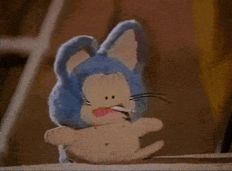 a stuffed bunny with a cigarette in its mouth is sitting on a ledge