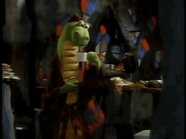 a green and yellow dinosaur is standing in front of a stained glass window holding a cup of coffee .