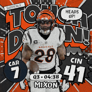 a bengals football player is holding a football in his hand