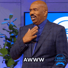 a man in a suit says awww in front of a plant