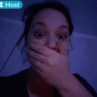 a woman is covering her mouth in front of a host sign