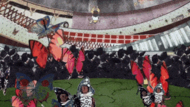 a group of butterflies are flying in a stadium with a person standing on the ceiling above them