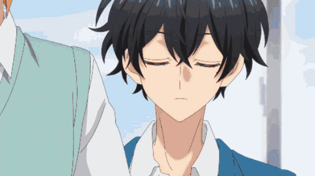 a boy with his eyes closed stands next to another boy