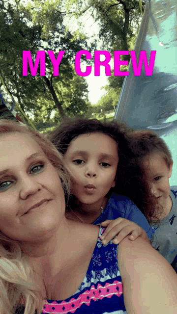a woman and two children are posing for a picture with the words " my crew " behind them
