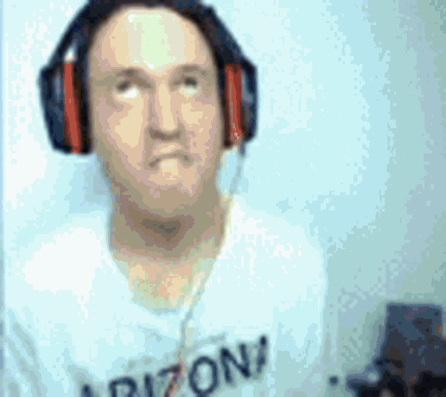 a man wearing headphones and a white shirt with the word arizona on it