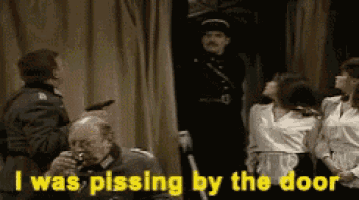 a group of people standing in front of a sign that says ' i was pissing by the door '