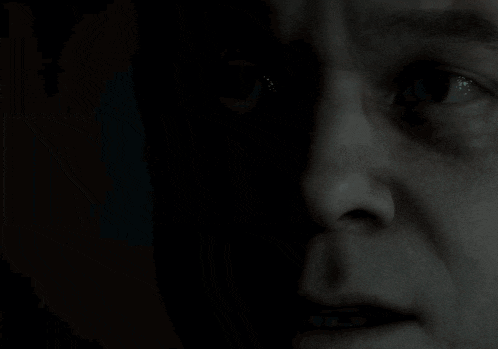 a close up of a man 's face in the dark