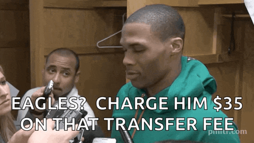 a man in a green hoodie is being interviewed by a reporter and the caption says eagles charge him $ 35 on that transfer fee
