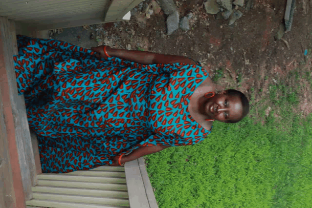 a woman in a leopard print dress is standing on a wooden staircase