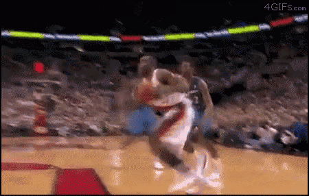 a basketball game is being played in a stadium with a crowd watching