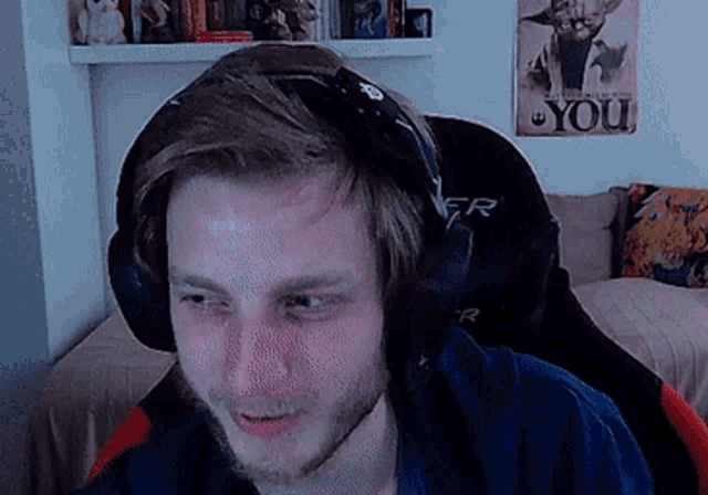 a man wearing headphones is sitting in a chair in front of a poster that says you