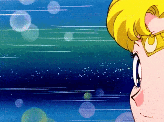 a close up of a cartoon character 's face with a crescent moon on her head