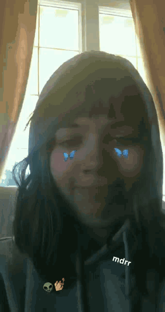 a girl wearing a hoodie with a sticker that says mdrr on it