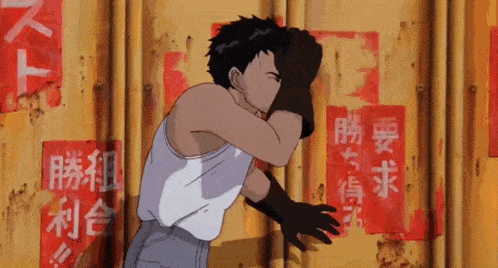 a man in a white tank top is standing in front of a wall with asian writing on it