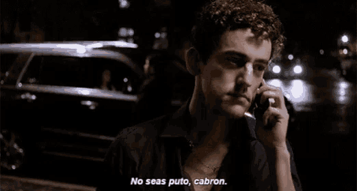 a man with curly hair is talking on a cell phone and says no seas puto cabron .