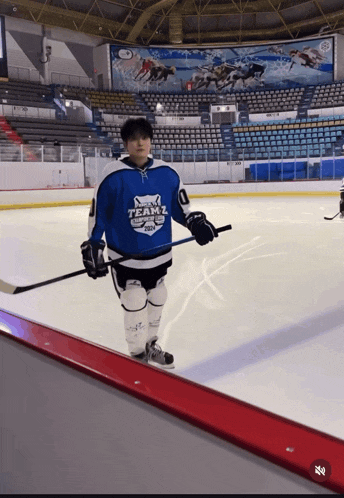 a hockey player in a blue team 2 jersey
