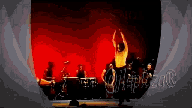 a man is dancing on a stage in front of a red background with the word olapizar on it