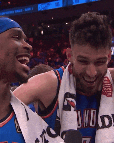 two basketball players are laughing and one has a towel around his neck that says thunder