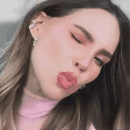 a close up of a woman making a funny face with her tongue out