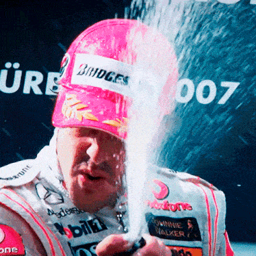 a man wearing a pink hat that says bridges