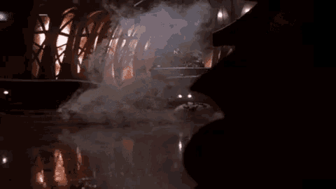 a dark room with smoke coming out of a container