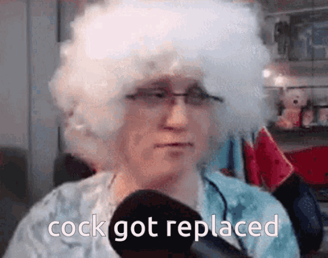a man with a white wig and glasses says cock got replaced