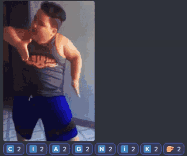 a boy in a tank top and blue shorts is dancing in a video