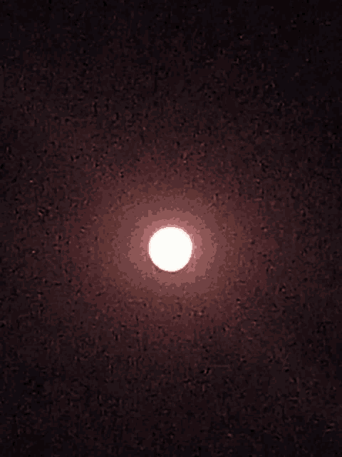 a full moon in a dark night sky