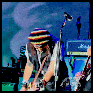 a man playing a guitar with a marshall amp in the background