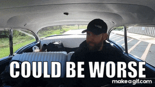 a man in a car with the words " could be worse "