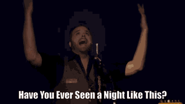 a man singing into a microphone with the words have you ever seen a night like this below him
