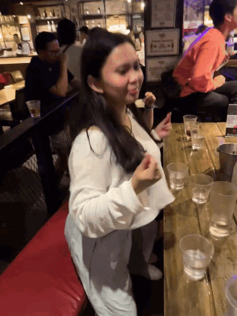 a woman sitting at a table with a sign that says ' a ' on it