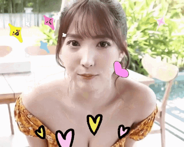 a woman 's chest is surrounded by hearts and smiley faces