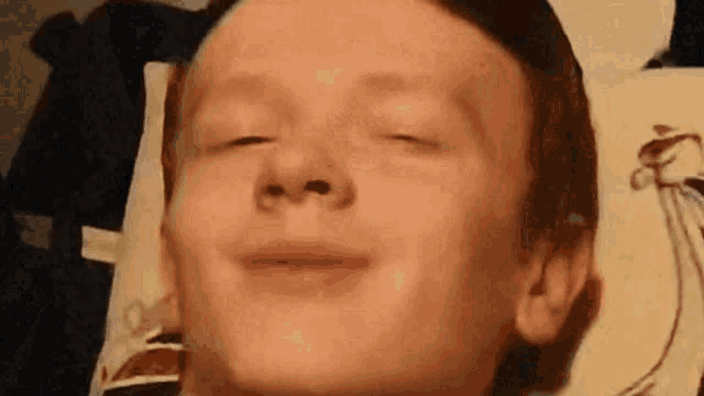 a close up of a person 's face with their eyes closed