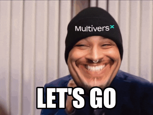 a man wearing a hat that says multivers on it smiles and says let 's go
