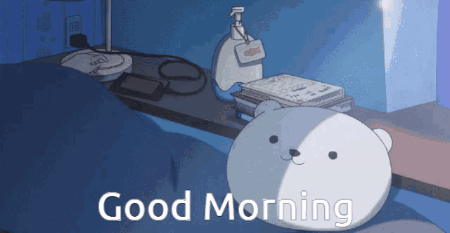 a cartoon bear is laying on a bed with the words " good morning " below it