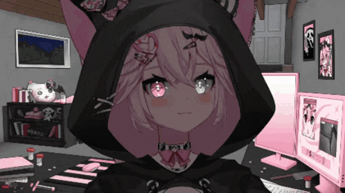 a girl wearing a black hoodie with bunny ears is standing in front of two computer monitors