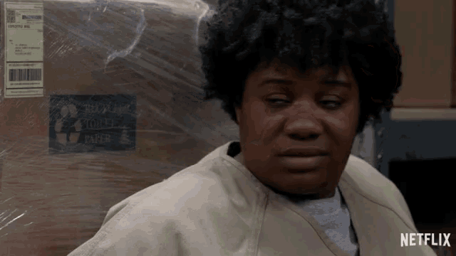 a woman is sitting in front of a box that says recycle paper