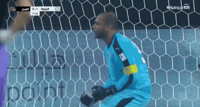a soccer goalie stands in front of a soccer net with a score of 0-1