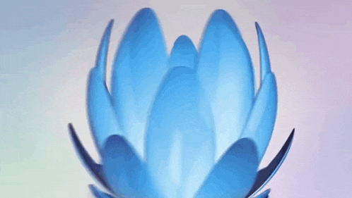 a blue flower made out of plastic spoons on a purple and blue background .
