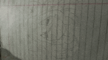 a drawing of a cartoon character is on a piece of lined paper