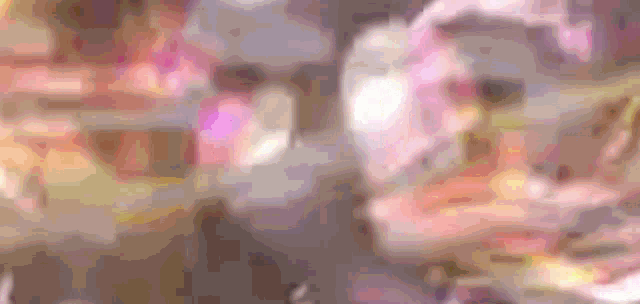 a blurred image of a person 's face with a purple background