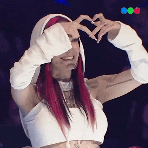 a woman making a heart shape with her hands