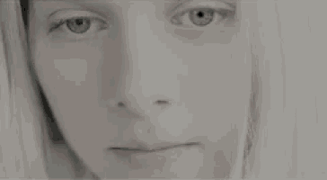 a close up of a woman 's face with blue eyes .