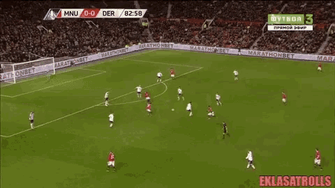 a soccer game is being played on a field with a crowd watching