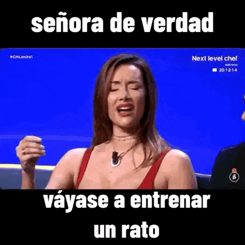 a woman in a red top is crying while sitting on a stage .