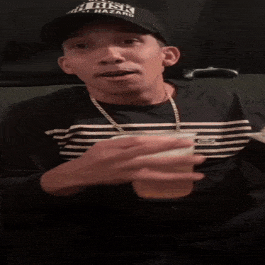 a man wearing a black hat that says risk on it