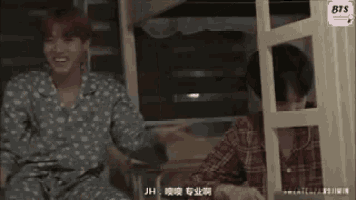 a man in a plaid shirt is laughing next to another man in a polka dot shirt