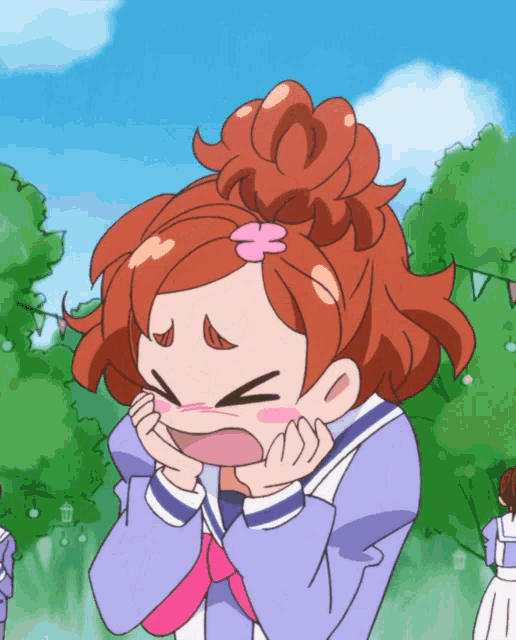 a girl with red hair and a pink flower in her hair is making a funny face