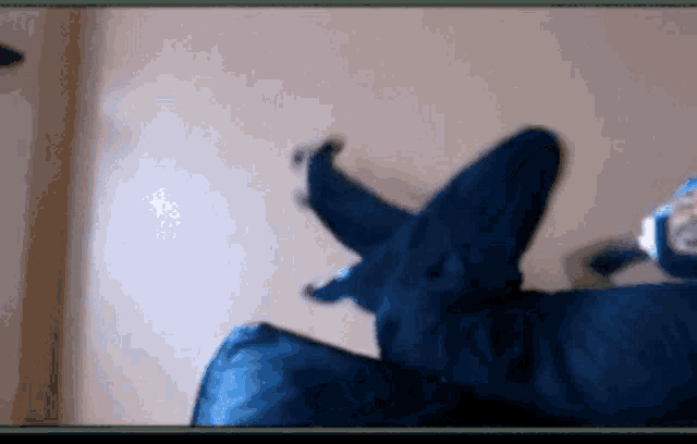 a blurry picture of a person laying on a bed with their feet crossed